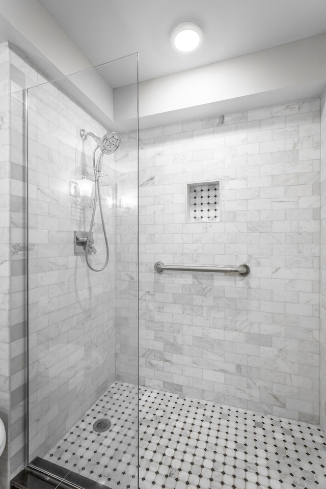 bathroom with a shower stall and toilet