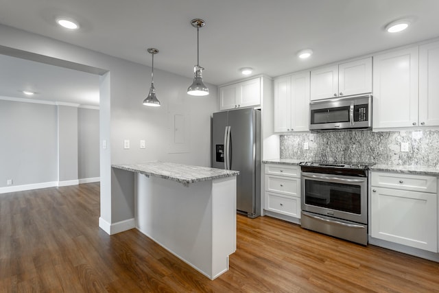 kitchen featuring stainless steel appliances, white cabinetry, dark wood-type flooring, and decorative backsplash