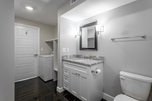 bathroom featuring tile patterned floors, vanity, and toilet