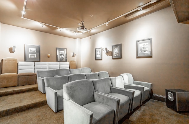 home theater room featuring carpet and track lighting