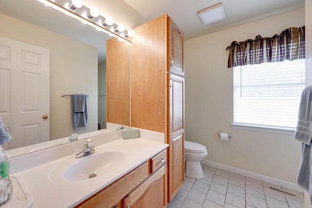 bathroom featuring vanity, toilet, and tile patterned floors