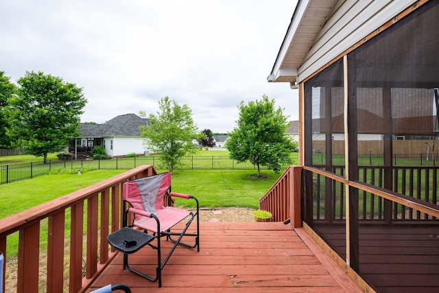 wooden deck with a sunroom and a yard