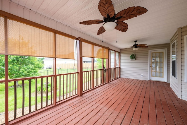 wooden deck featuring ceiling fan and a yard