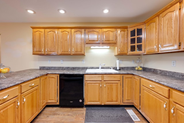 kitchen featuring light wood-type flooring, dishwasher, and sink