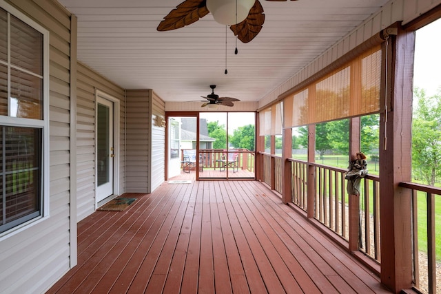 unfurnished sunroom featuring ceiling fan