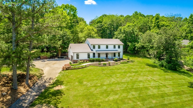 colonial home with a front yard and a garage