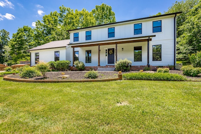 view of front of home with covered porch and a front lawn