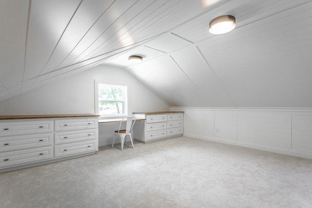 bonus room featuring light colored carpet and vaulted ceiling