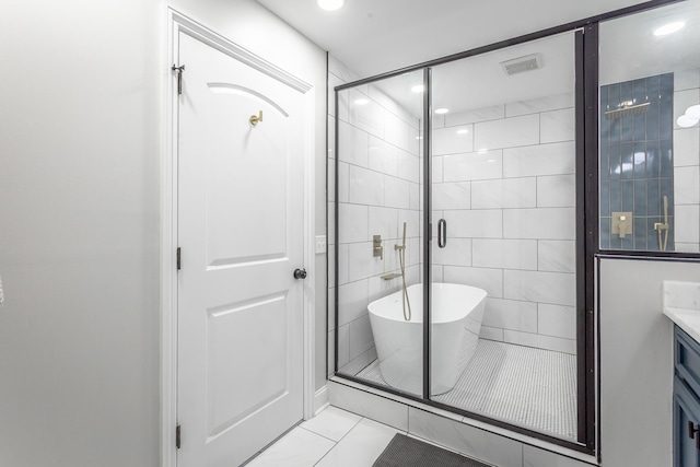 bathroom with vanity, tile patterned floors, independent shower and bath, and tile walls