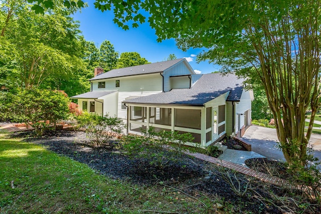 back of house with a sunroom