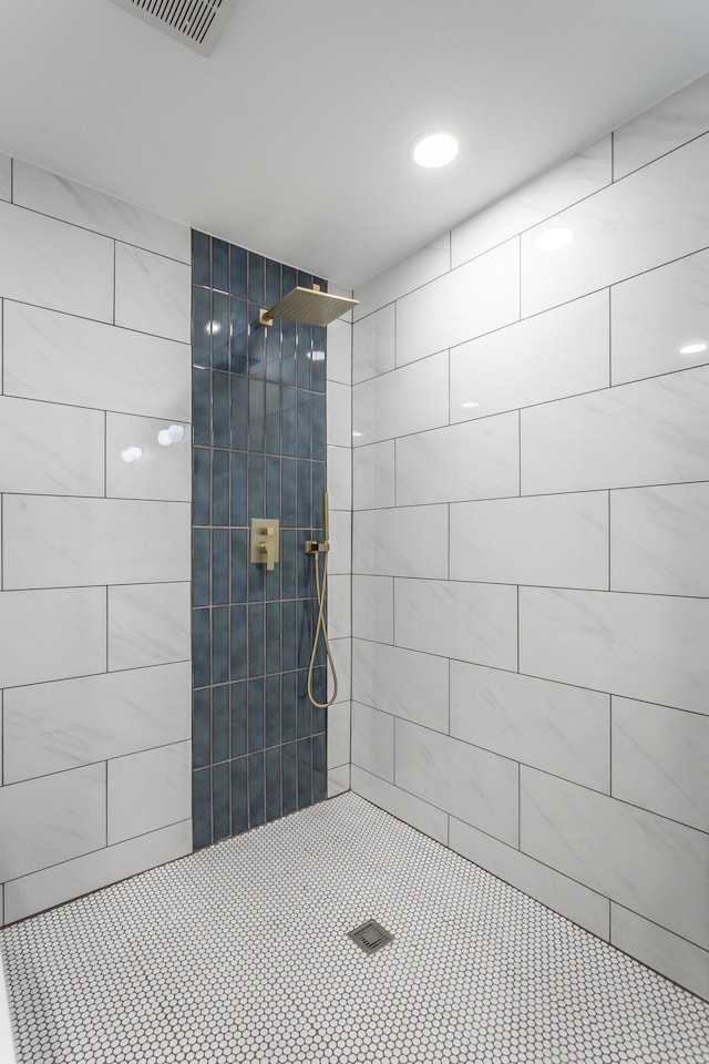 bathroom with a tile shower