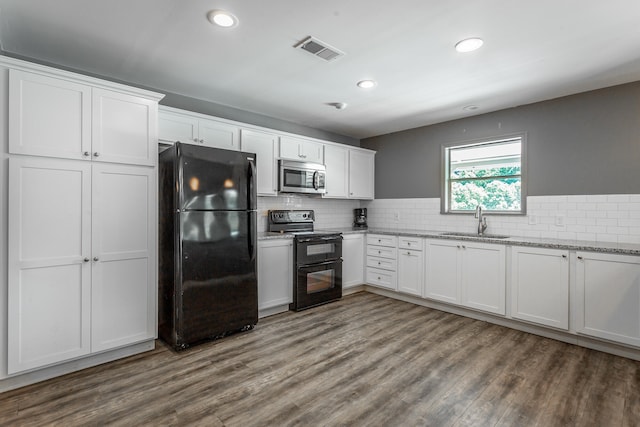 kitchen featuring white cabinetry, black appliances, sink, and wood-type flooring