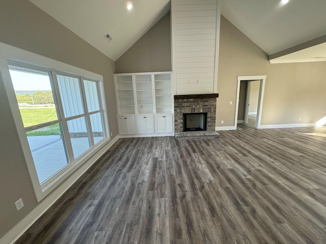 unfurnished living room with high vaulted ceiling and dark hardwood / wood-style floors