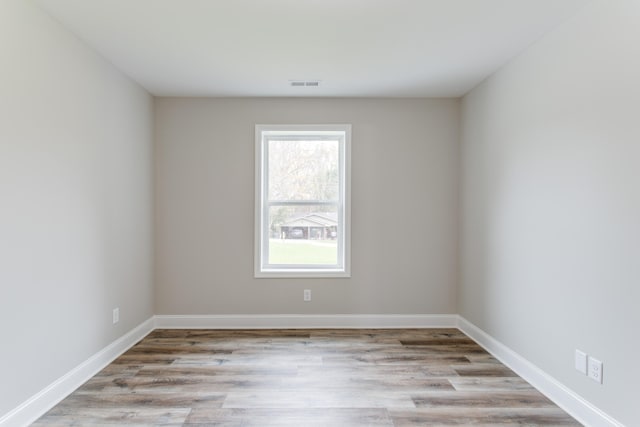 unfurnished room with light wood-type flooring