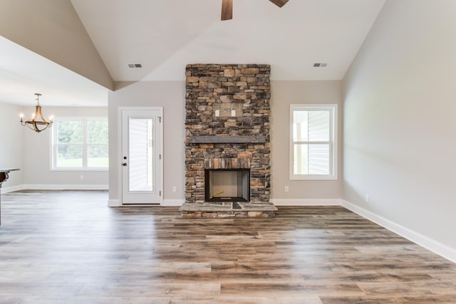 unfurnished living room with hardwood / wood-style flooring, plenty of natural light, and vaulted ceiling