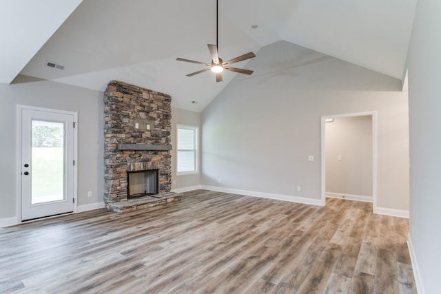 unfurnished living room with a fireplace, light hardwood / wood-style floors, ceiling fan, and a healthy amount of sunlight