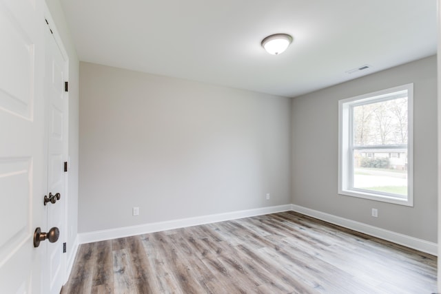 spare room featuring light hardwood / wood-style floors