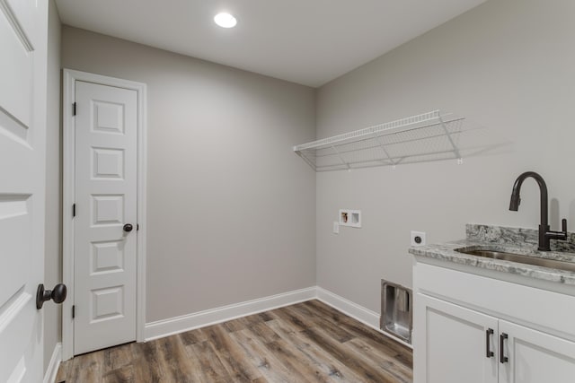 washroom featuring electric dryer hookup, dark hardwood / wood-style flooring, sink, and hookup for a washing machine