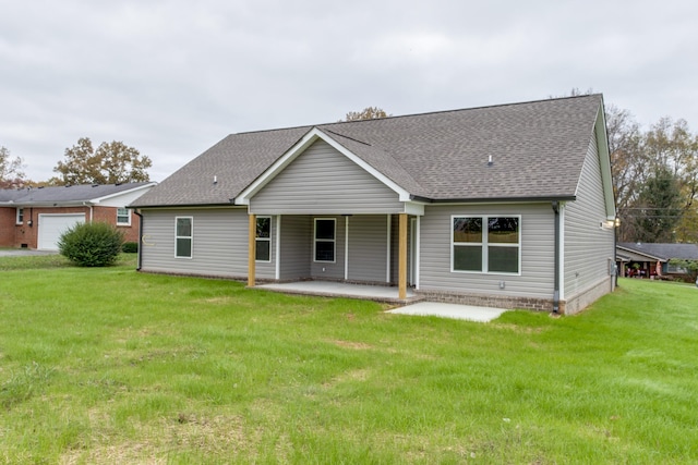 rear view of house featuring a yard