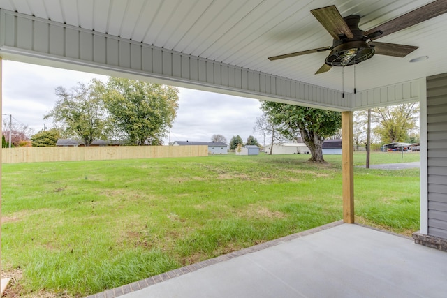 view of yard with ceiling fan and a patio area