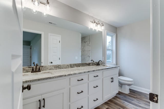 bathroom featuring hardwood / wood-style floors, vanity, and toilet