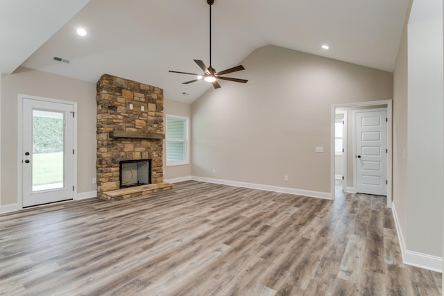 unfurnished living room with a fireplace, light hardwood / wood-style floors, high vaulted ceiling, and ceiling fan