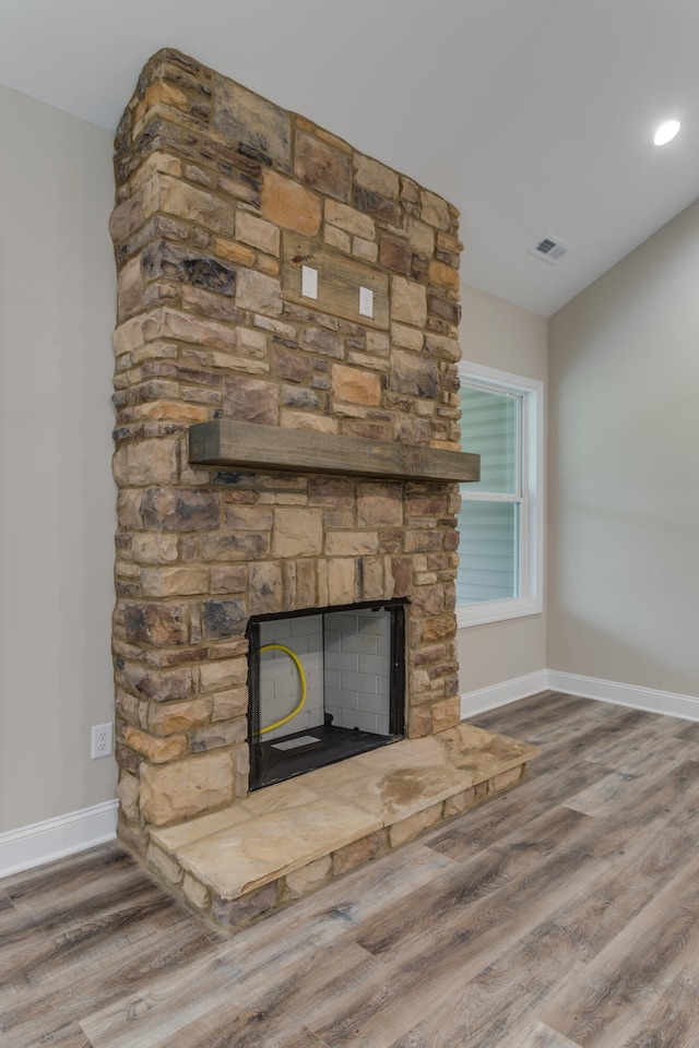 interior details featuring a fireplace and hardwood / wood-style flooring