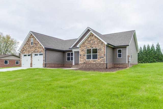 view of front of home with a front yard and a garage