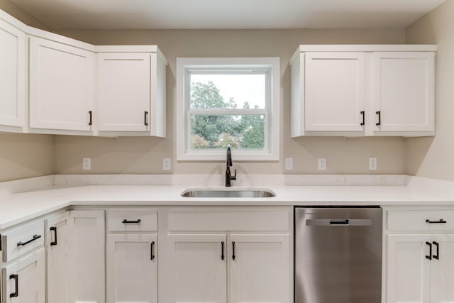 kitchen with white cabinetry, stainless steel dishwasher, and sink