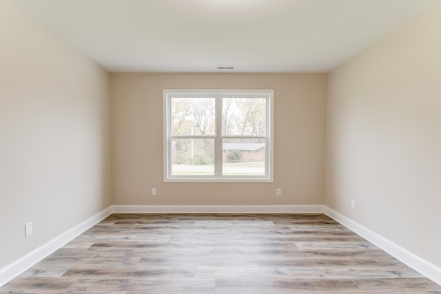 unfurnished room with light wood-type flooring