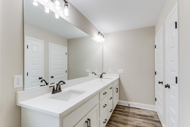 bathroom with hardwood / wood-style floors and vanity