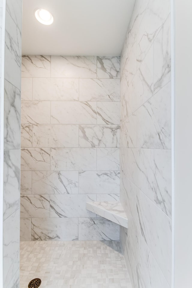 bathroom with tiled shower