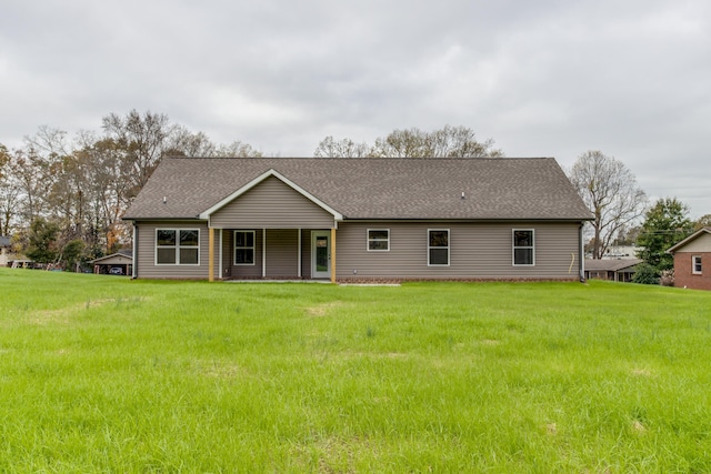 back of property featuring a lawn