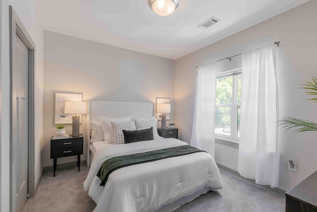 bedroom featuring light colored carpet