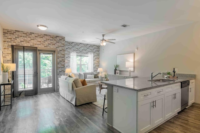 kitchen featuring light stone counters, white cabinets, ceiling fan, dishwasher, and dark hardwood / wood-style flooring