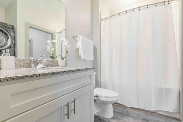 bathroom featuring hardwood / wood-style floors, vanity, and toilet