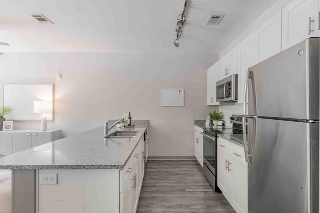 kitchen featuring light wood-type flooring, sink, white cabinets, appliances with stainless steel finishes, and light stone countertops