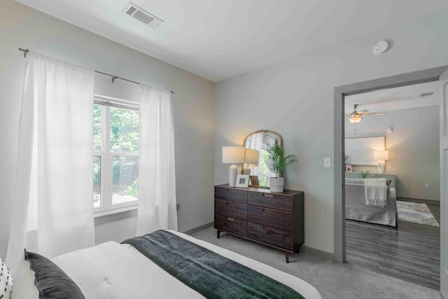 carpeted bedroom featuring multiple windows