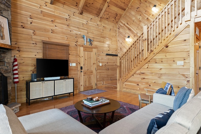 living room featuring wood ceiling, beam ceiling, high vaulted ceiling, wooden walls, and hardwood / wood-style floors