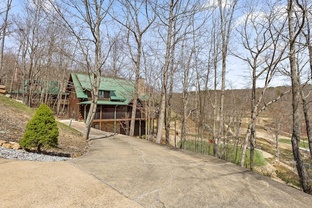 835 Rushing Water Trl, Rising Fawn, GA 30738 - view of front facade featuring a chimney, concrete driveway, log siding, and a porch