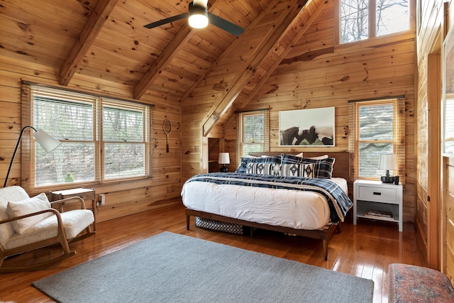 bedroom with wood ceiling, wood walls, beamed ceiling, wood-type flooring, and ceiling fan