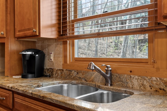 kitchen featuring decorative backsplash, plenty of natural light, and sink