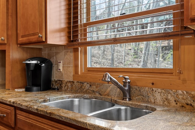 835 Rushing Water Trl, Rising Fawn, GA 30738 - kitchen featuring a sink, brown cabinets, and backsplash