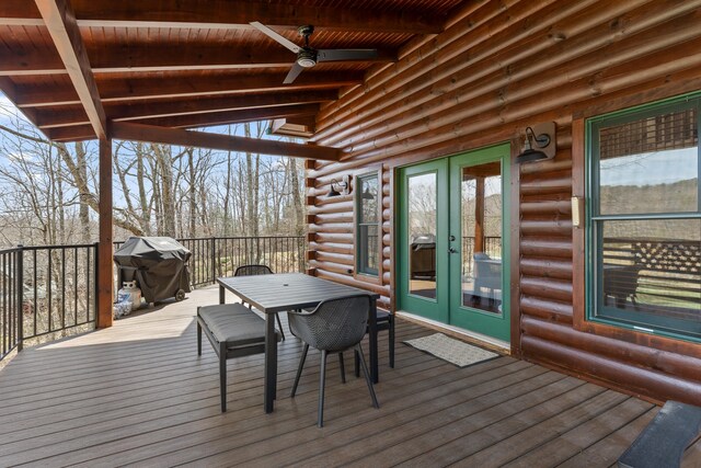 wooden terrace featuring ceiling fan, grilling area, and french doors