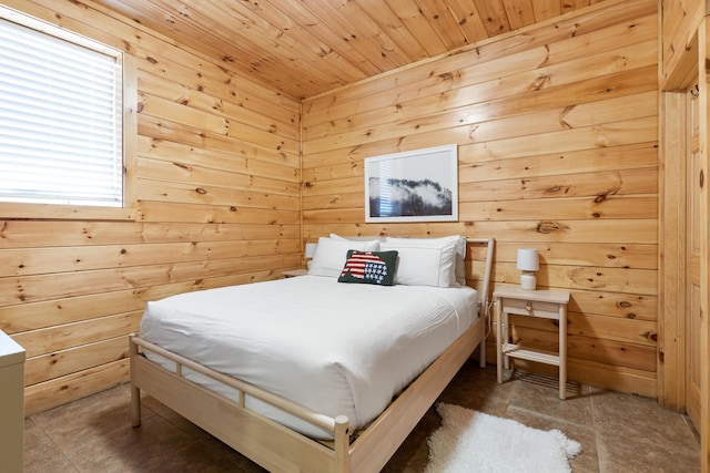 bedroom with wood walls and multiple windows