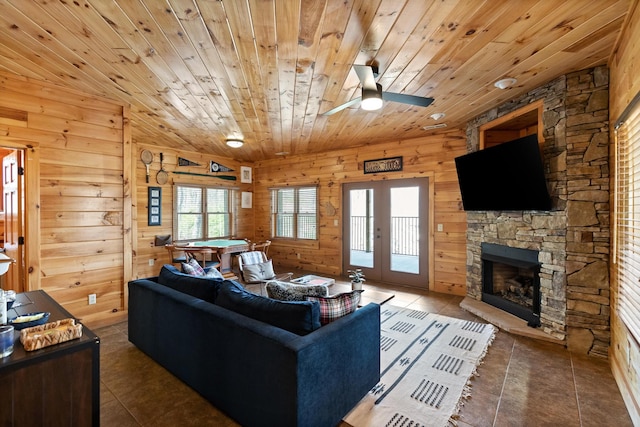 835 Rushing Water Trl, Rising Fawn, GA 30738 - living area with wood ceiling, tile patterned floors, wood walls, a fireplace, and a ceiling fan