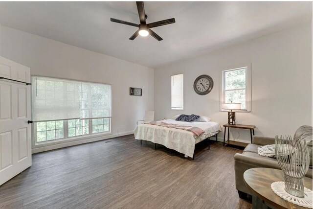 bedroom with ceiling fan and dark wood-type flooring