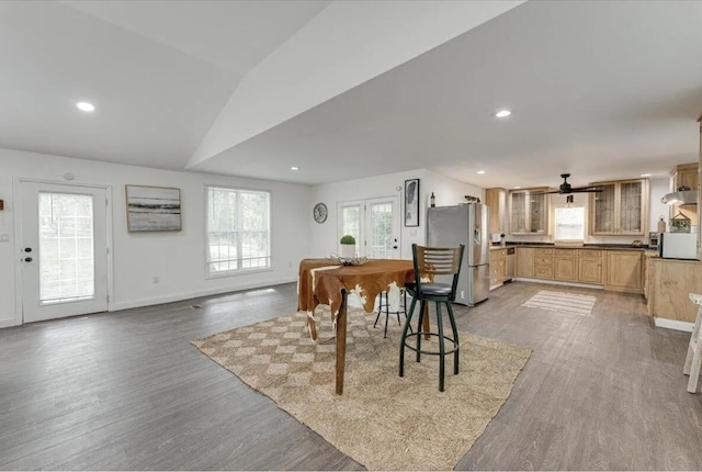 dining area featuring ceiling fan, lofted ceiling, and hardwood / wood-style floors