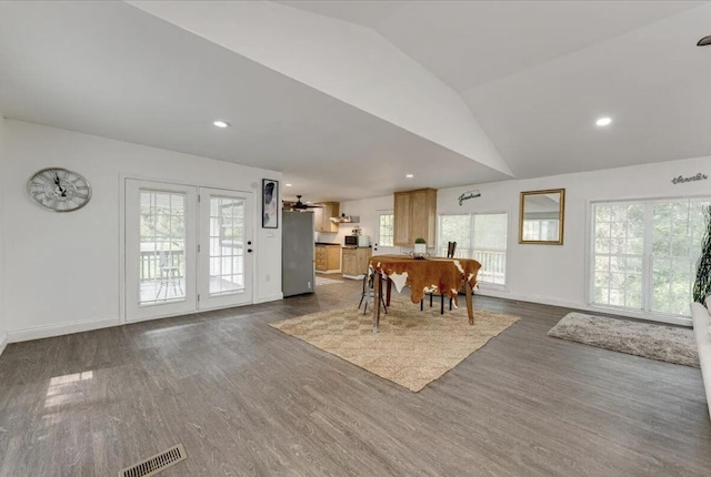 dining area featuring lofted ceiling, dark hardwood / wood-style flooring, and a wealth of natural light