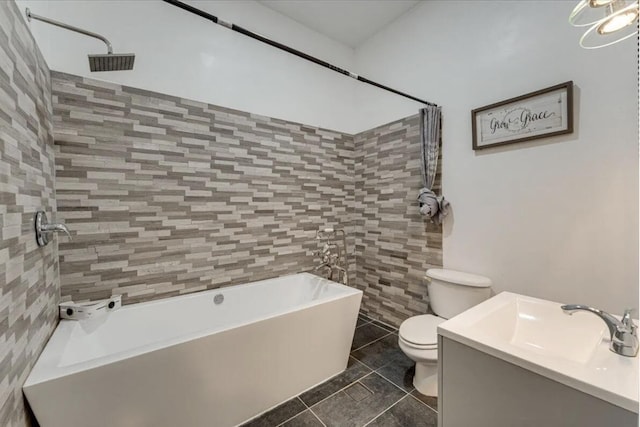 full bathroom featuring tile walls, vanity, toilet,  shower combination, and tile patterned floors